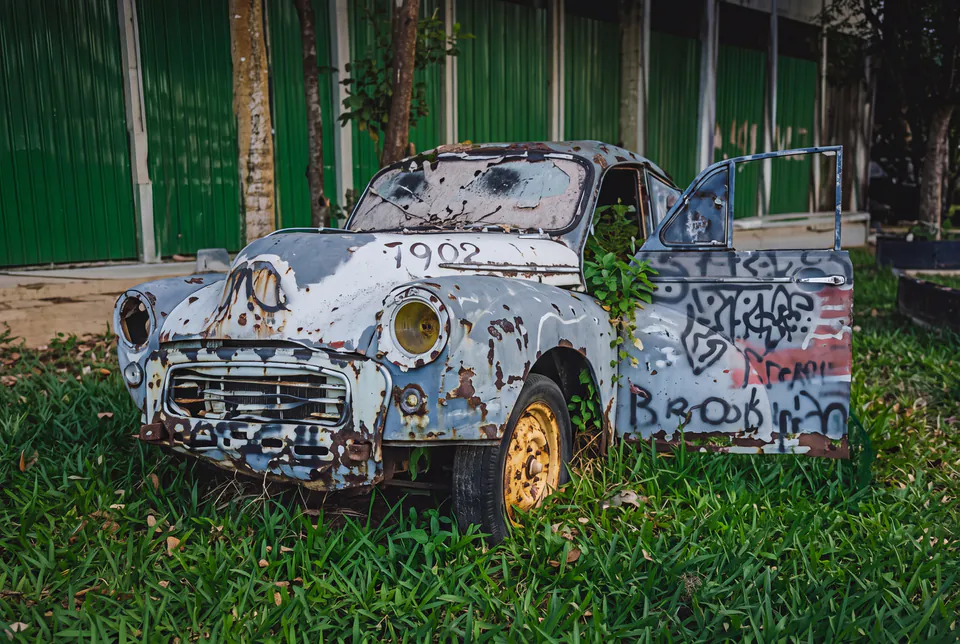The same abandoned car, sharp and detailed after enhancement