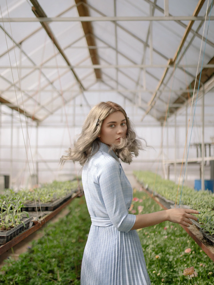 Woman in a greenhouse before digital-art styling